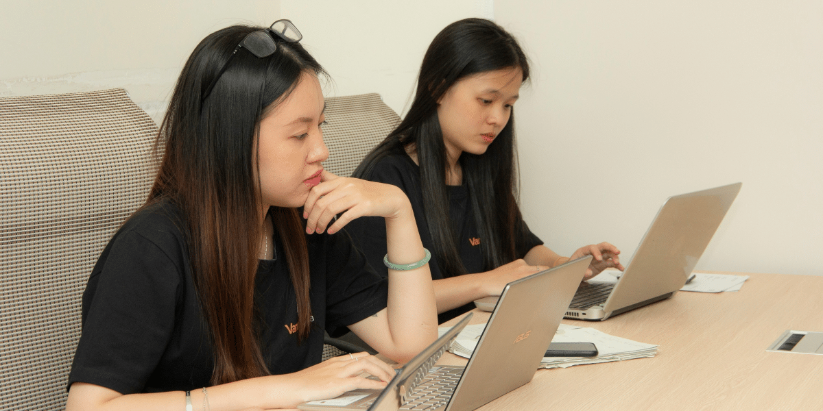2 women working using their laptops
