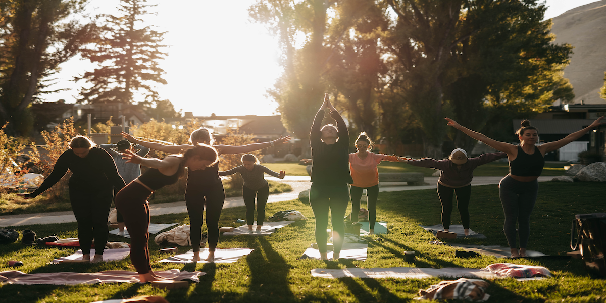 Image commercially licensed from https://unsplash.com/photos/a-group-of-people-doing-yoga-in-a-park-nmHSysCA_Mk